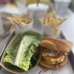 Lettuce wrap burger and a classic burger with fries.