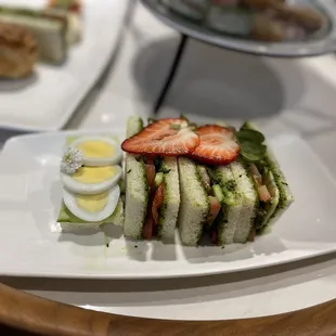 "Veggie" sandwiches. 3 of the same (basil/tomato) and 1 egg.