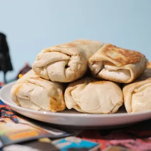 a plate of burritos on a table