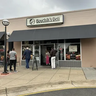 people standing outside of the store