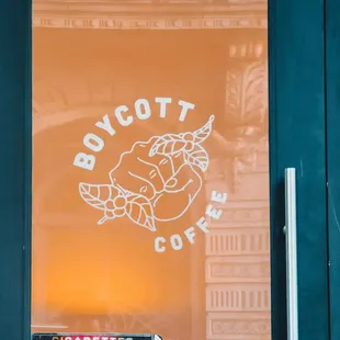 a cup of coffee on a table in front of a window