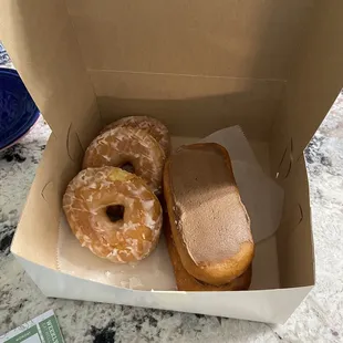 two glazed donuts in a box