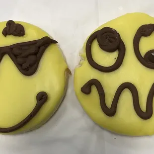 two smiley face donuts