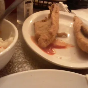 Fish served on dirty plate.