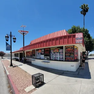 a man standing in front of a restaurant
