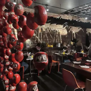 a restaurant with red apples hanging from the ceiling