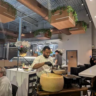 Chef cooking pasta at the table