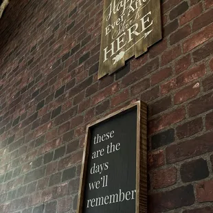 a sign on a brick wall