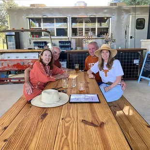 a group of people sitting at a picnic table