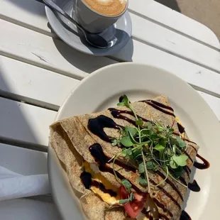 a plate of food and a cup of coffee