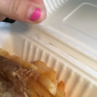 Hair literally cooked into the dredge of the chicken.