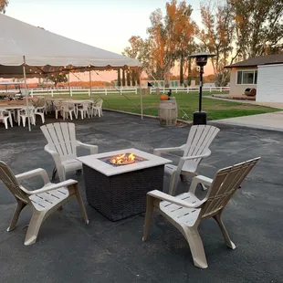 a fire pit with chairs around it
