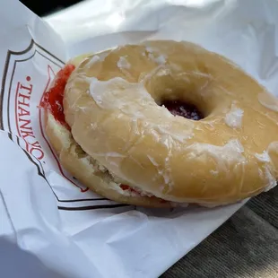 a glazed donut on a paper bag