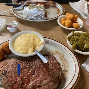 Prime rib, cheese grits, green beans, hush puppies, corn nuggets, baked potato and NY strip
