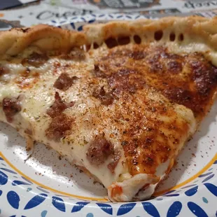 One slice of the sausage Double Decker pizza and one slice of the regular Double Decker pizza.