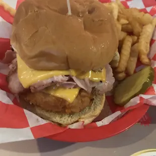 Piece of chicken coated in potato chips and deep-fried. Topped with ham and cheese.