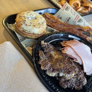 Everything bagel with smoked cream cheese, breakfast sausage, double smoked ham, candied bacon.