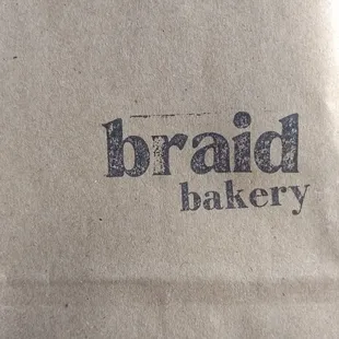 a brown paper bag with the word braid bakery on it
