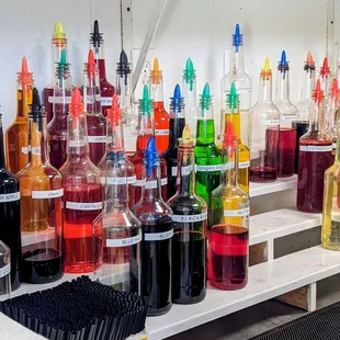 a variety of colored bottles