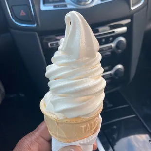 a hand holding an ice cream cone