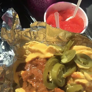 Chili cheese nachos w/ peppers and a Georgia peach &amp; pink lemonade snowball.