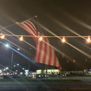 an american flag flying in the night
