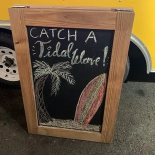 a chalk board with a surfboard on it