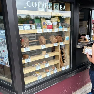 a woman looking in a coffee shop window