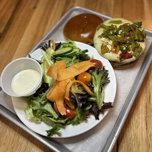 a plate of salad and a hot dog