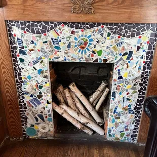The sitting area in the main room of the shop has a beautiful mosaic fireplace.