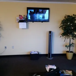 Other half of the waiting room. Tv remote is on the table to change channels.