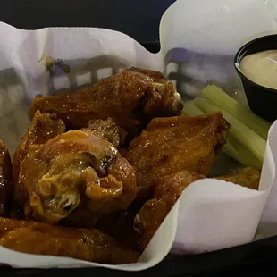 a basket of wings and celery