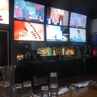 a bar with multiple televisions