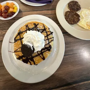 Oreo pancake with sausage, eggs, and a side of fruit