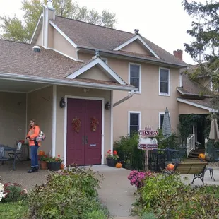 a woman standing in front of a house
