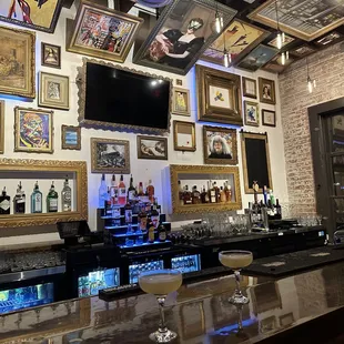 a wall of framed art