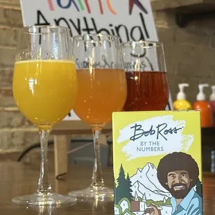 three glasses of beer and a book