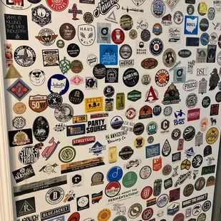 a refrigerator covered in stickers