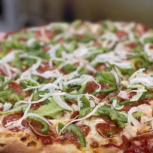 a hand holding a pizza