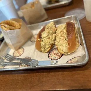 Smoked egg salad on lobster roll and onion rings.