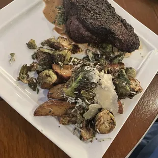 Coffee Crusted NY Prime Steak with truffle potatoes and brussels sprouts