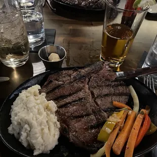 Porterhouse mashed potato's vegetable medley and cowboy butter.