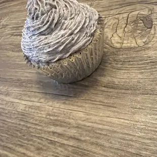 a cupcake on a wooden table