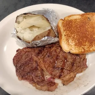 Delmonico steak with baked potato and Texas toast