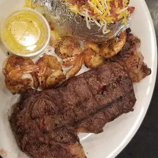 18oz ribeye with grilled shrimp and loaded baked potatoe