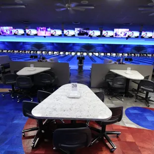a bowling alley with tables and chairs