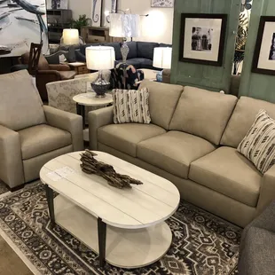 A leather sofa and recliner set