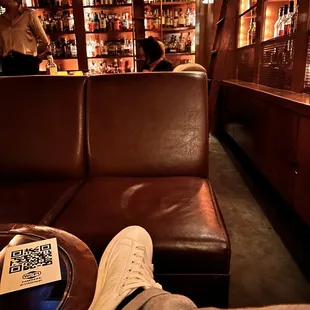 a person sitting on a couch in a bar