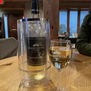 Sitting all around the winery while enjoying a bottle of wine.