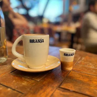 a cup and saucer on a wooden table